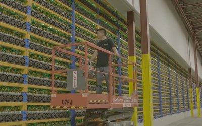 A modern mining farm with rows of mining machines